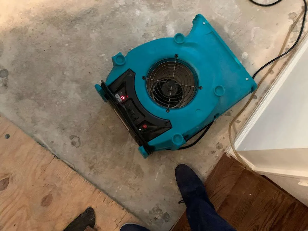 Air mover drying subfloor during Commercial Water Damage Restoration in Travis Ranch